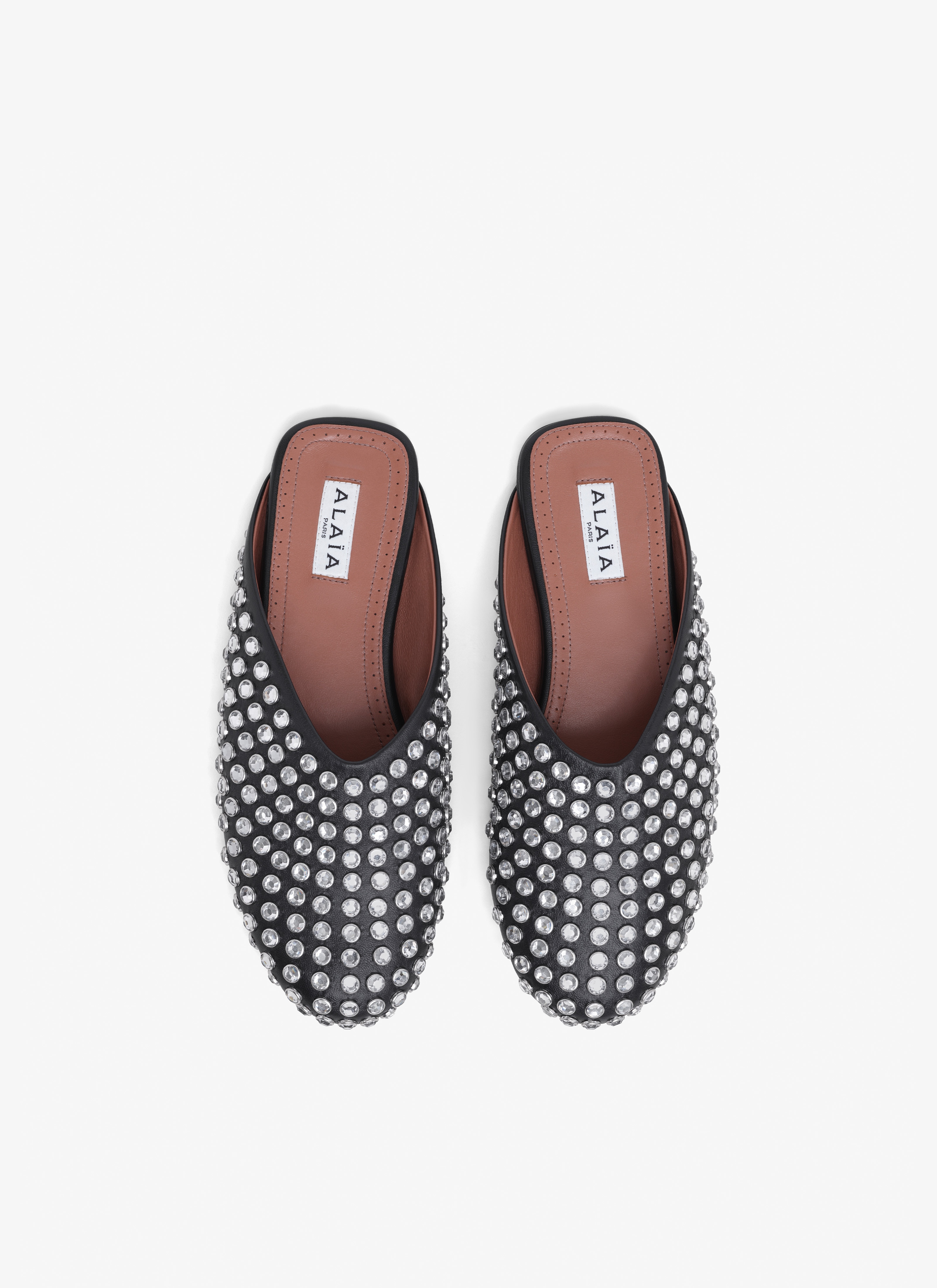 ALAÏA BLACK FLAT MULES IN STRASS LAMBSKIN