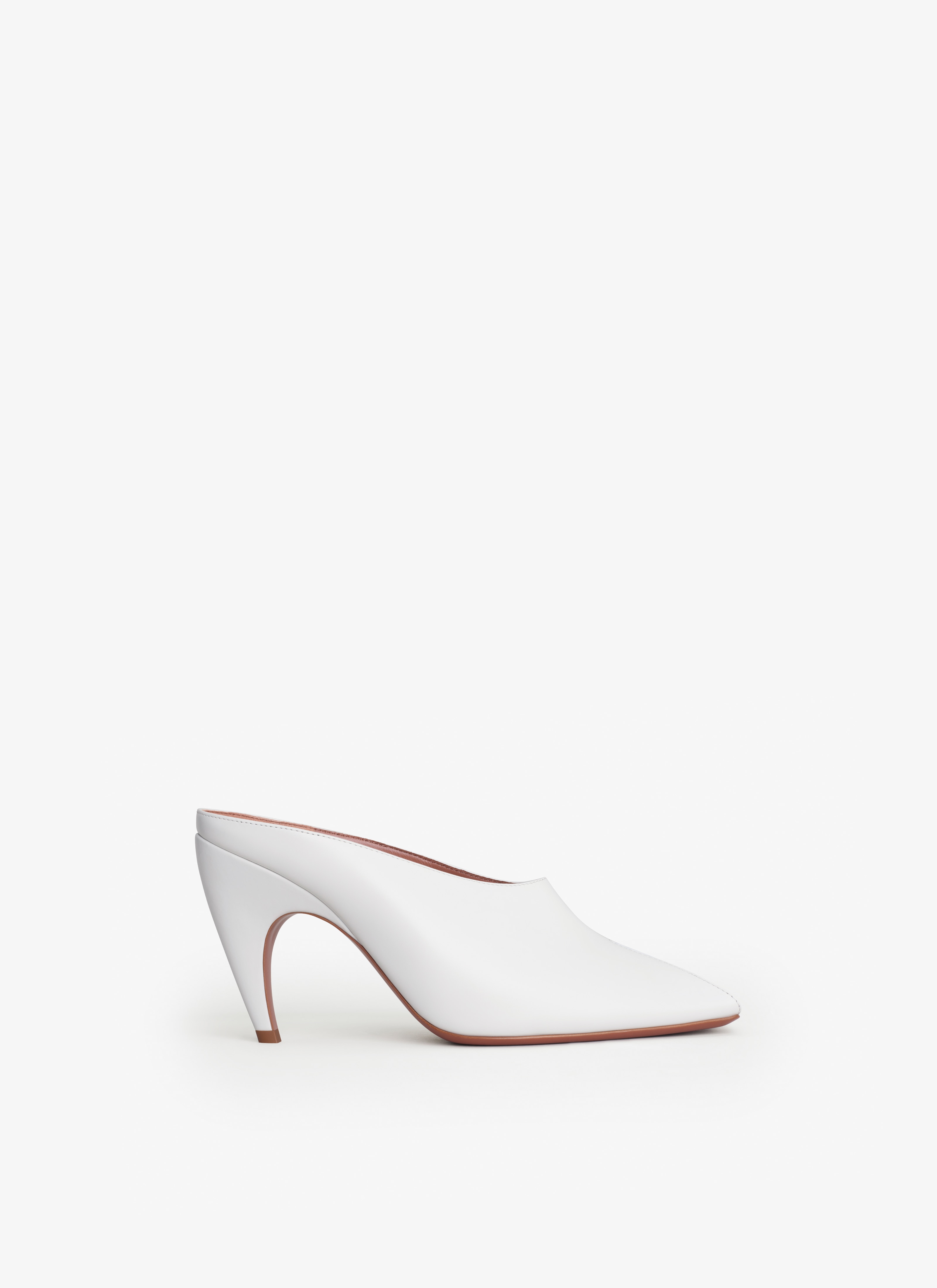 ALAÏA NUDE SPIKE MULES IN CALFSKIN
