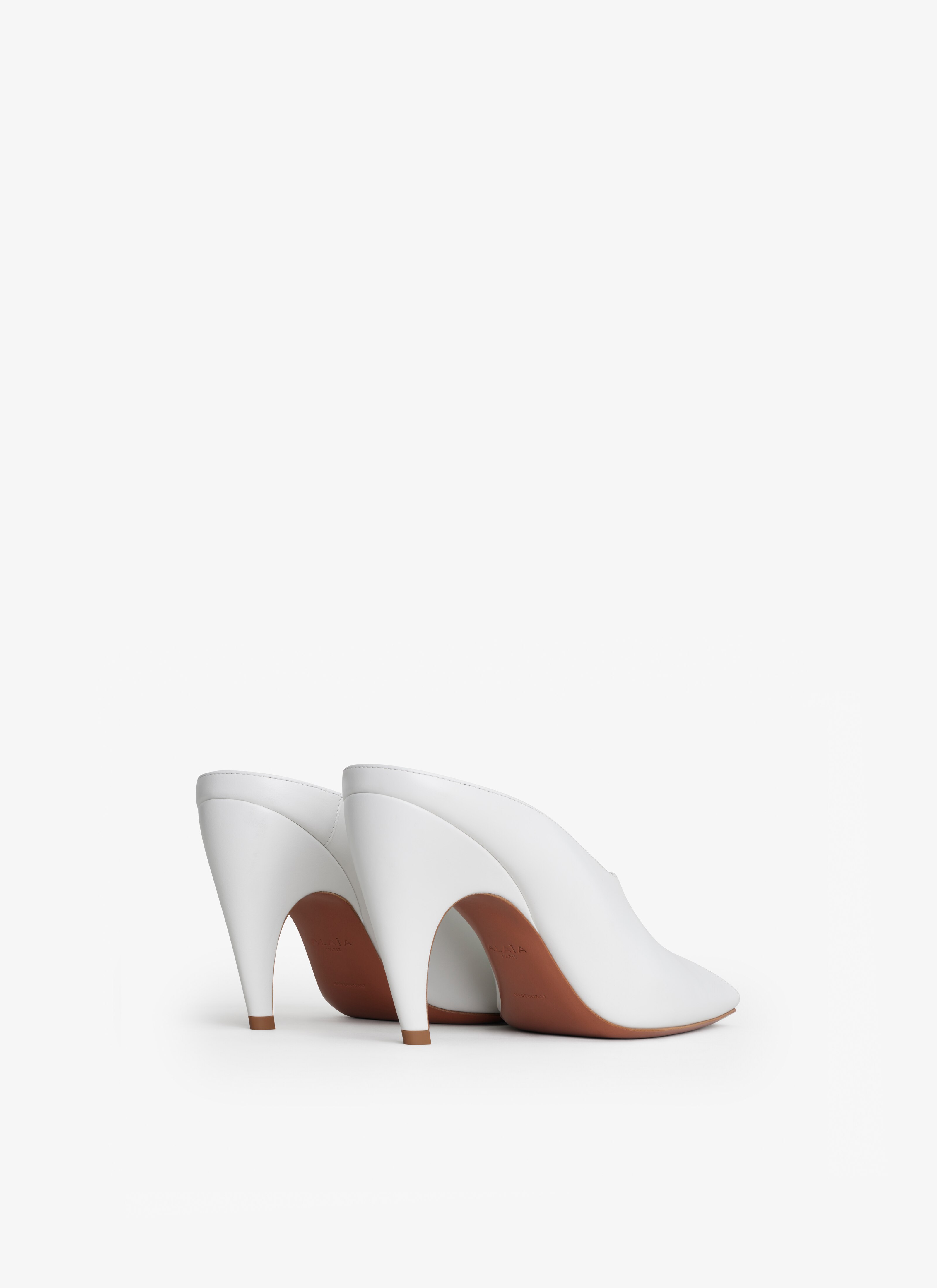 ALAÏA NUDE SPIKE MULES IN CALFSKIN
