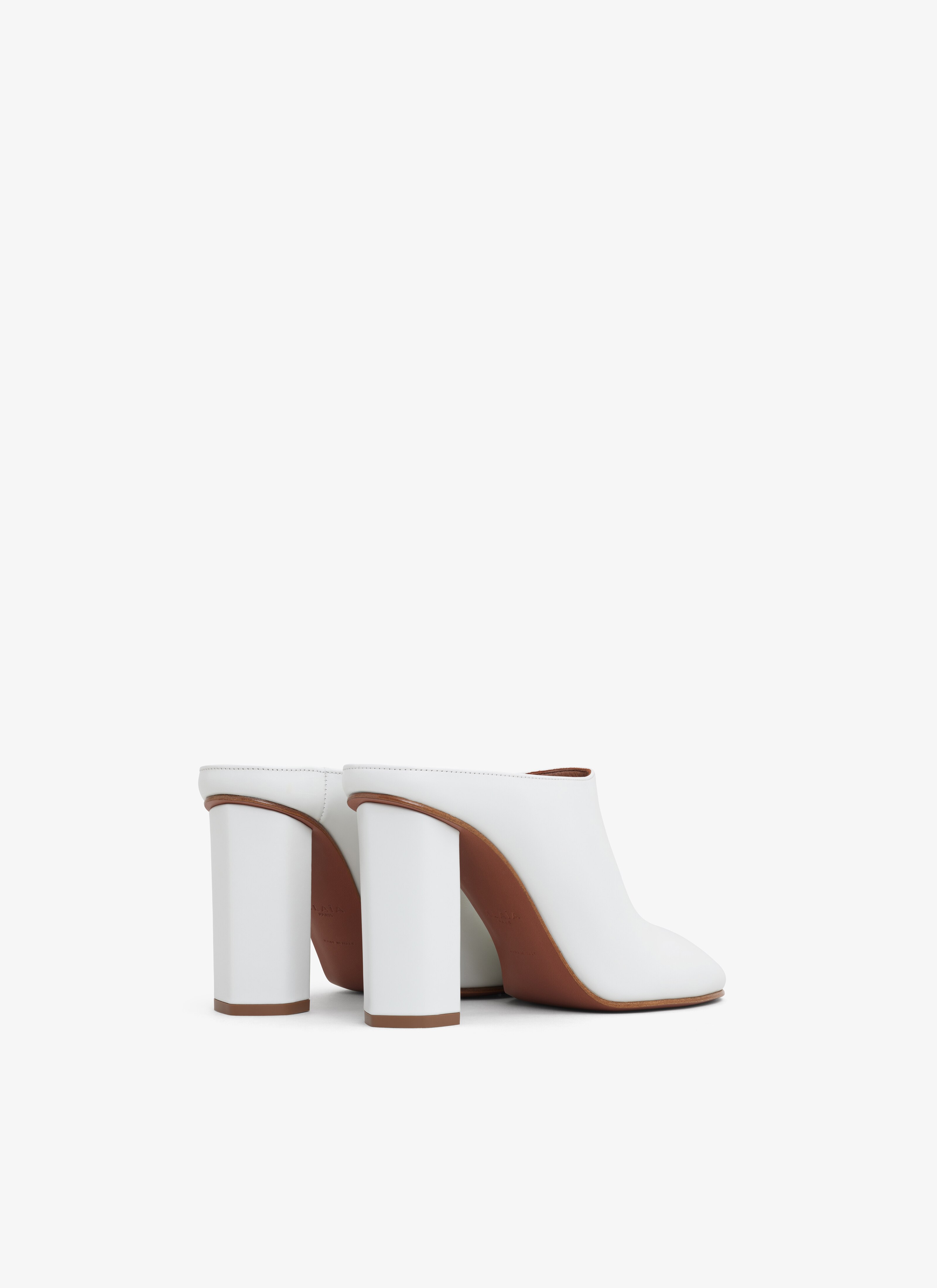 ALAÏA IVORY BABYLONE MULES IN CALFSKIN