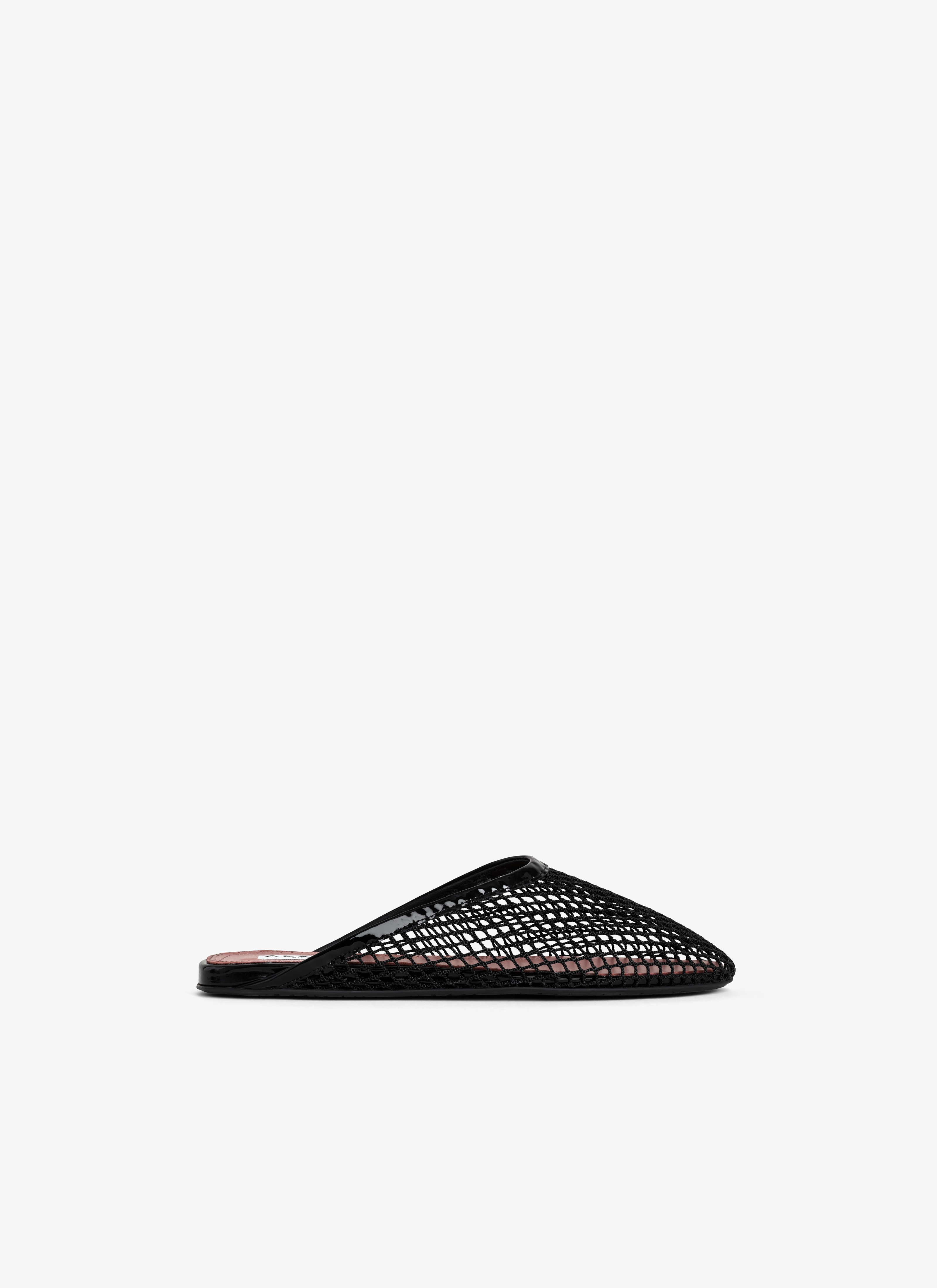 ALAÏA BLACK FLAT MULES IN FISHNET