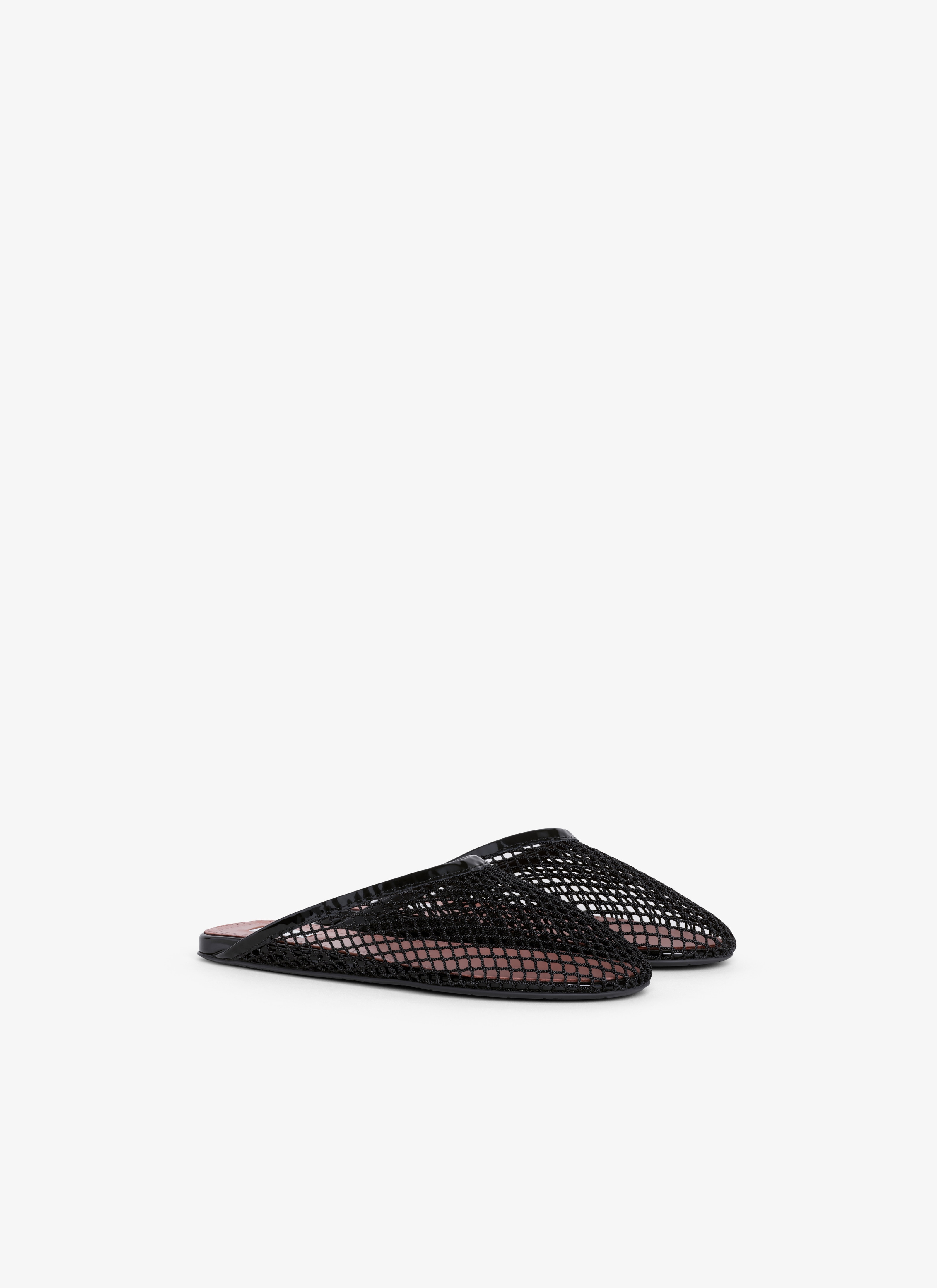 ALAÏA BLACK FLAT MULES IN FISHNET