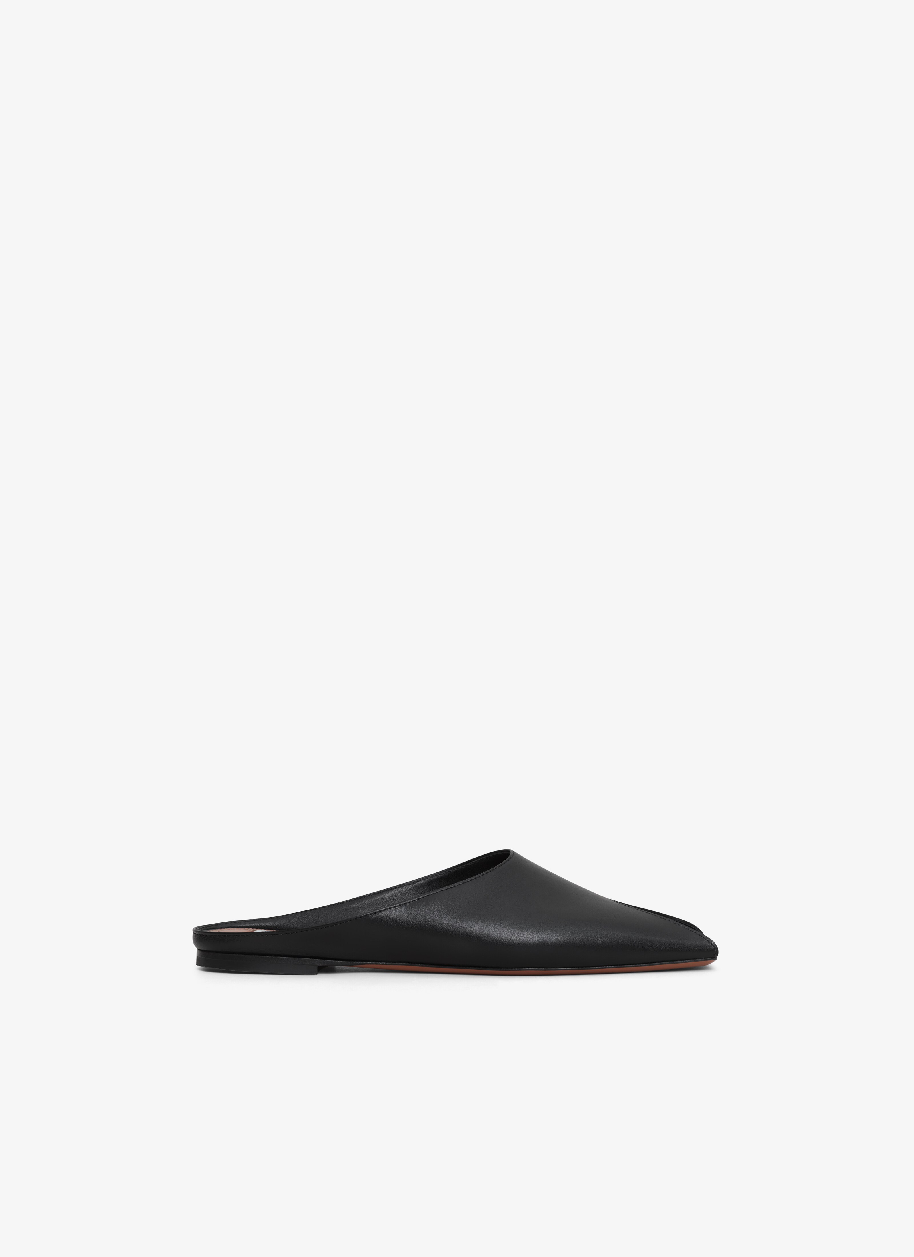 ALAÏA BLACK SPIKE FLAT MULES IN CALFSKIN