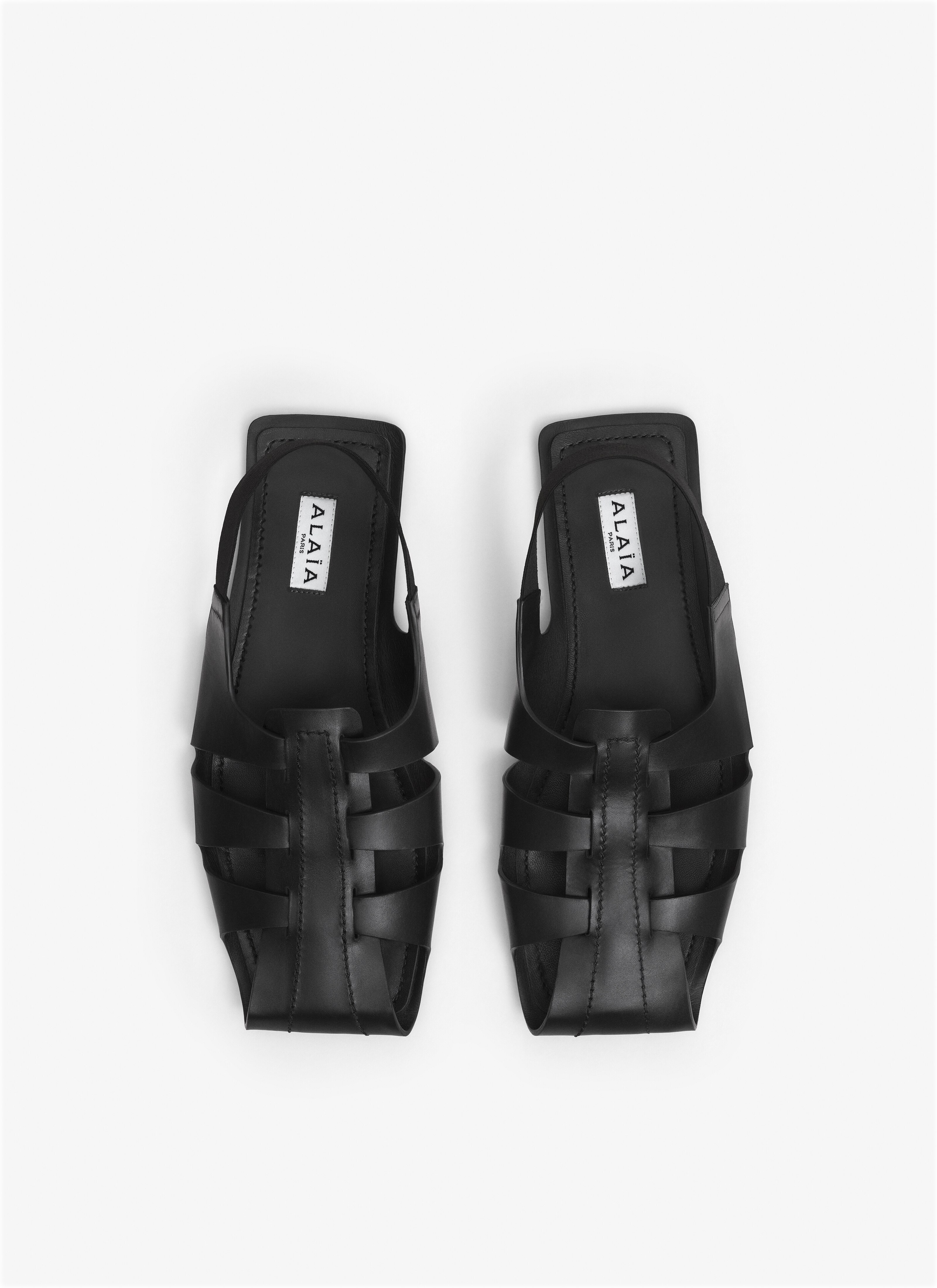 ALAÏA BLACK FOLDED FLAT SANDALS IN CALFSKIN