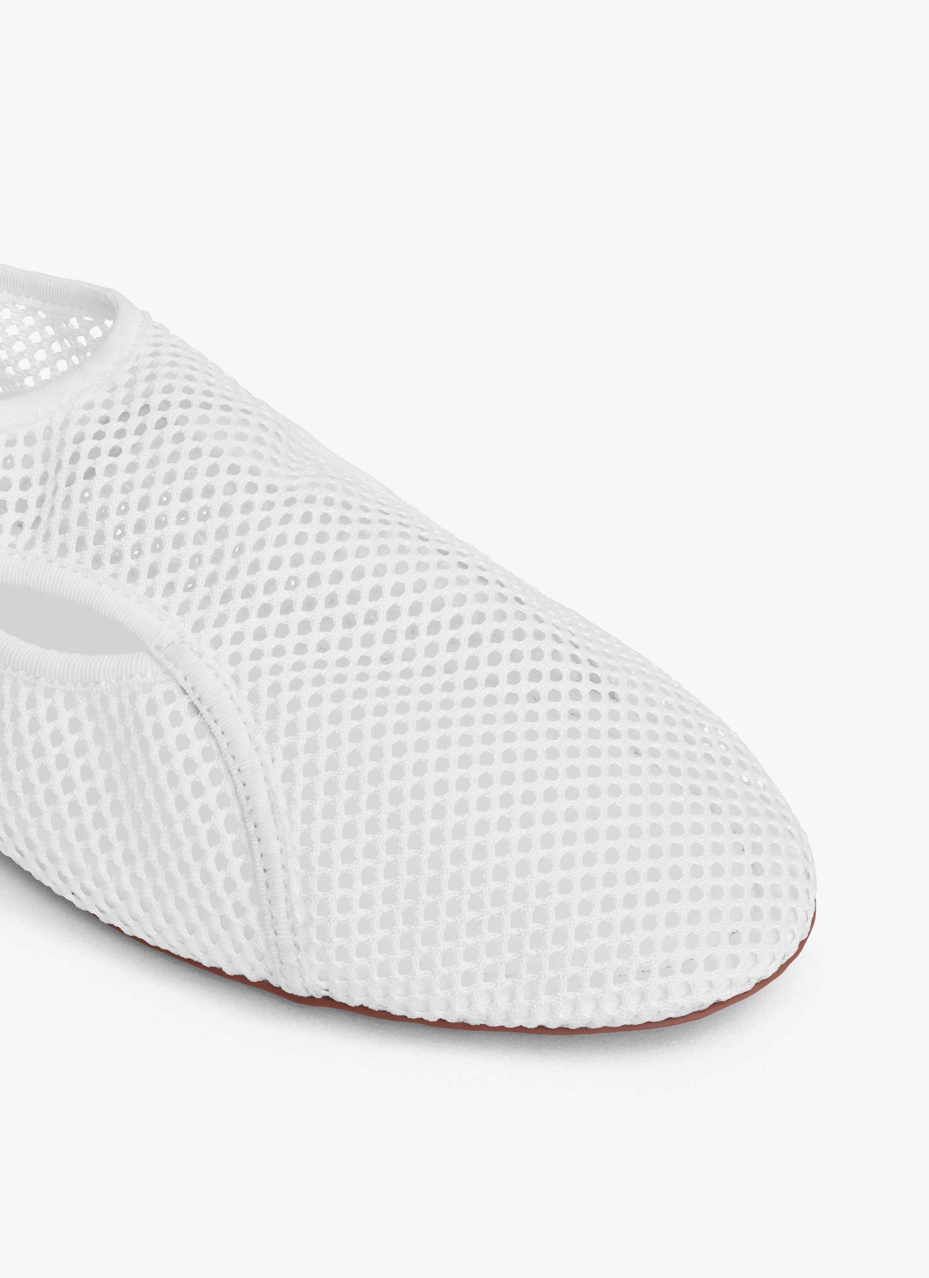 ALAÏA OPTIC WHITE SLIPPERS IN FISHNET