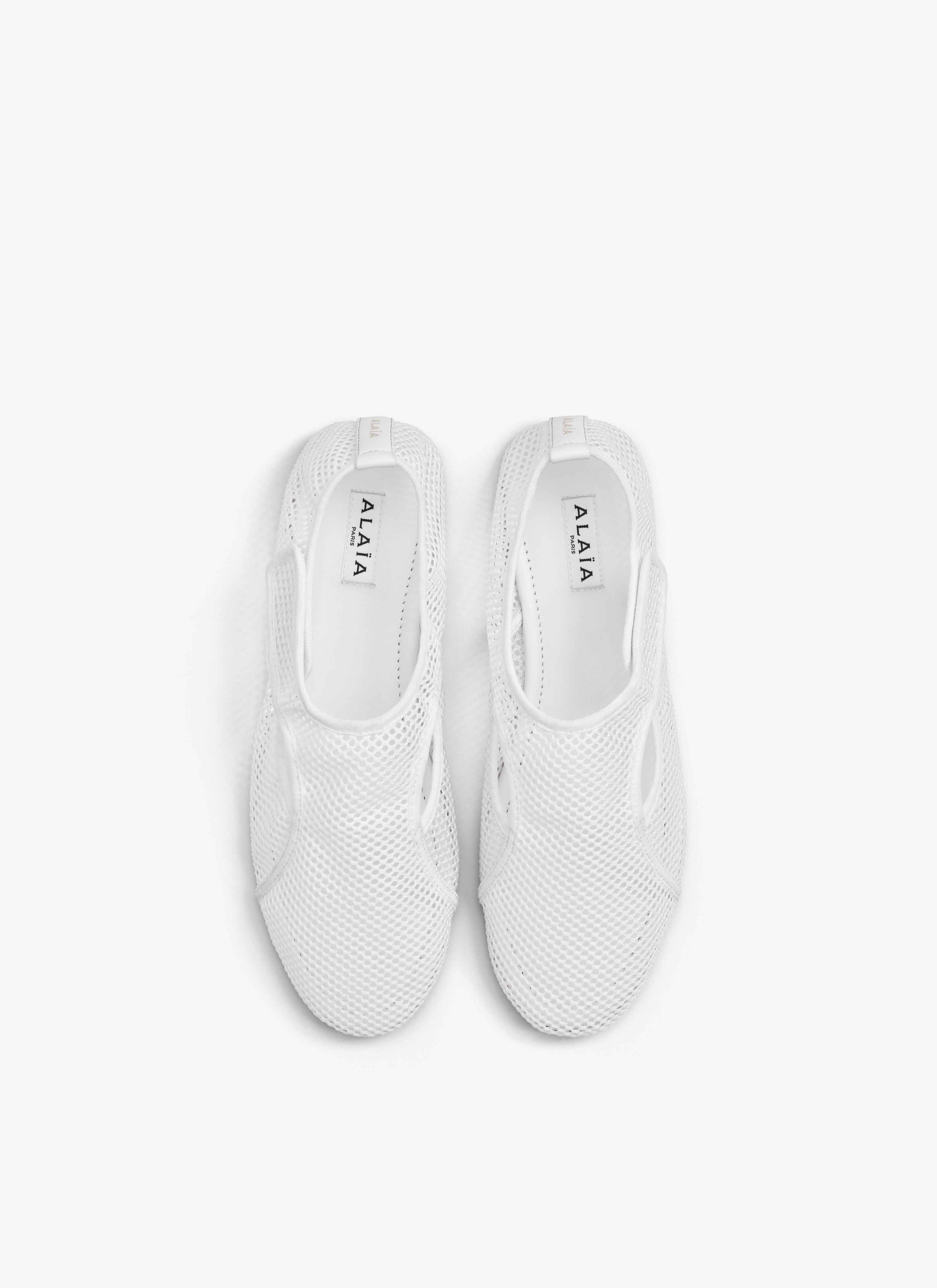 ALAÏA OPTIC WHITE SLIPPERS IN FISHNET