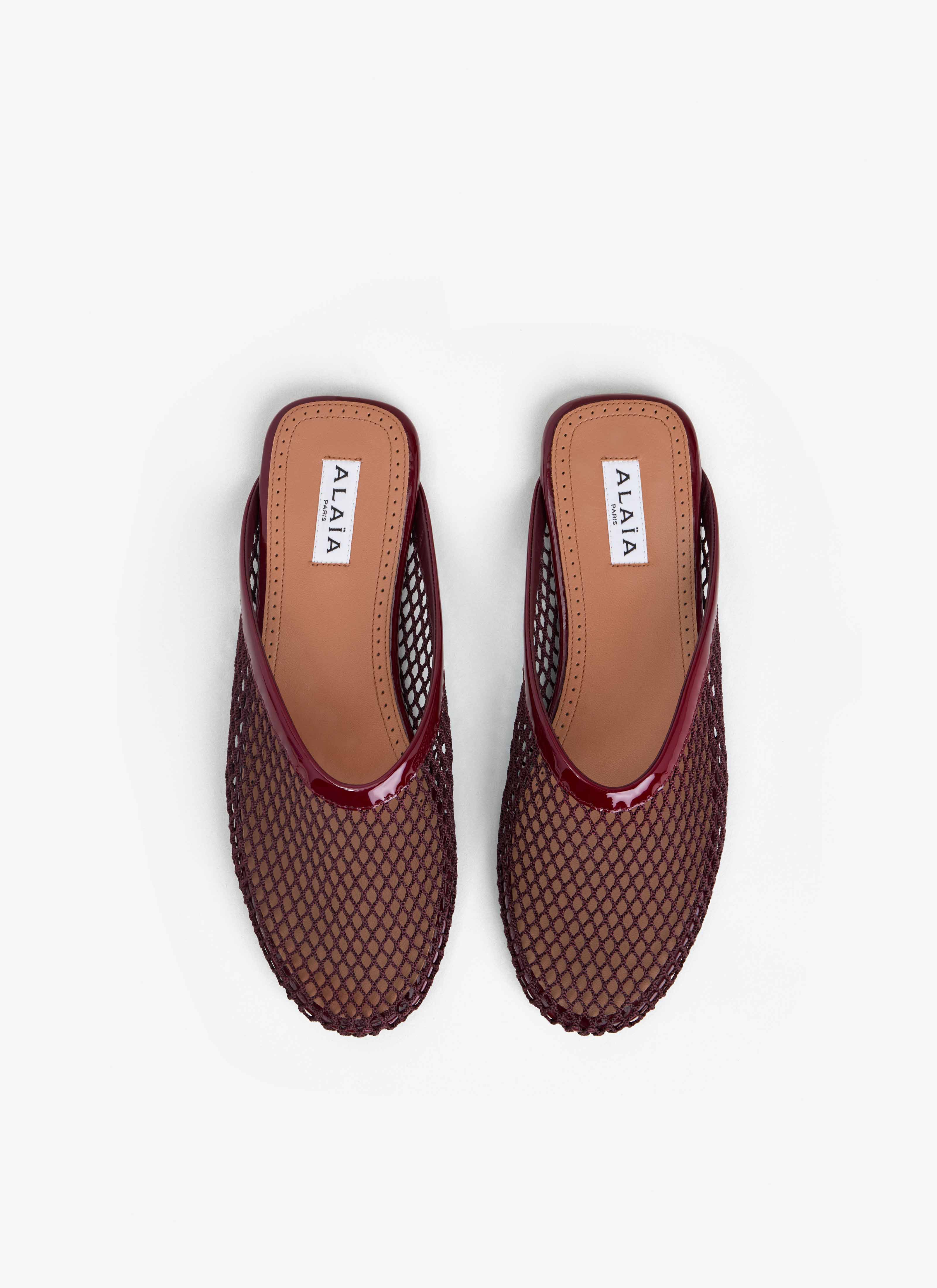 ALAÏA DARK RED FLAT MULES IN FISHNET