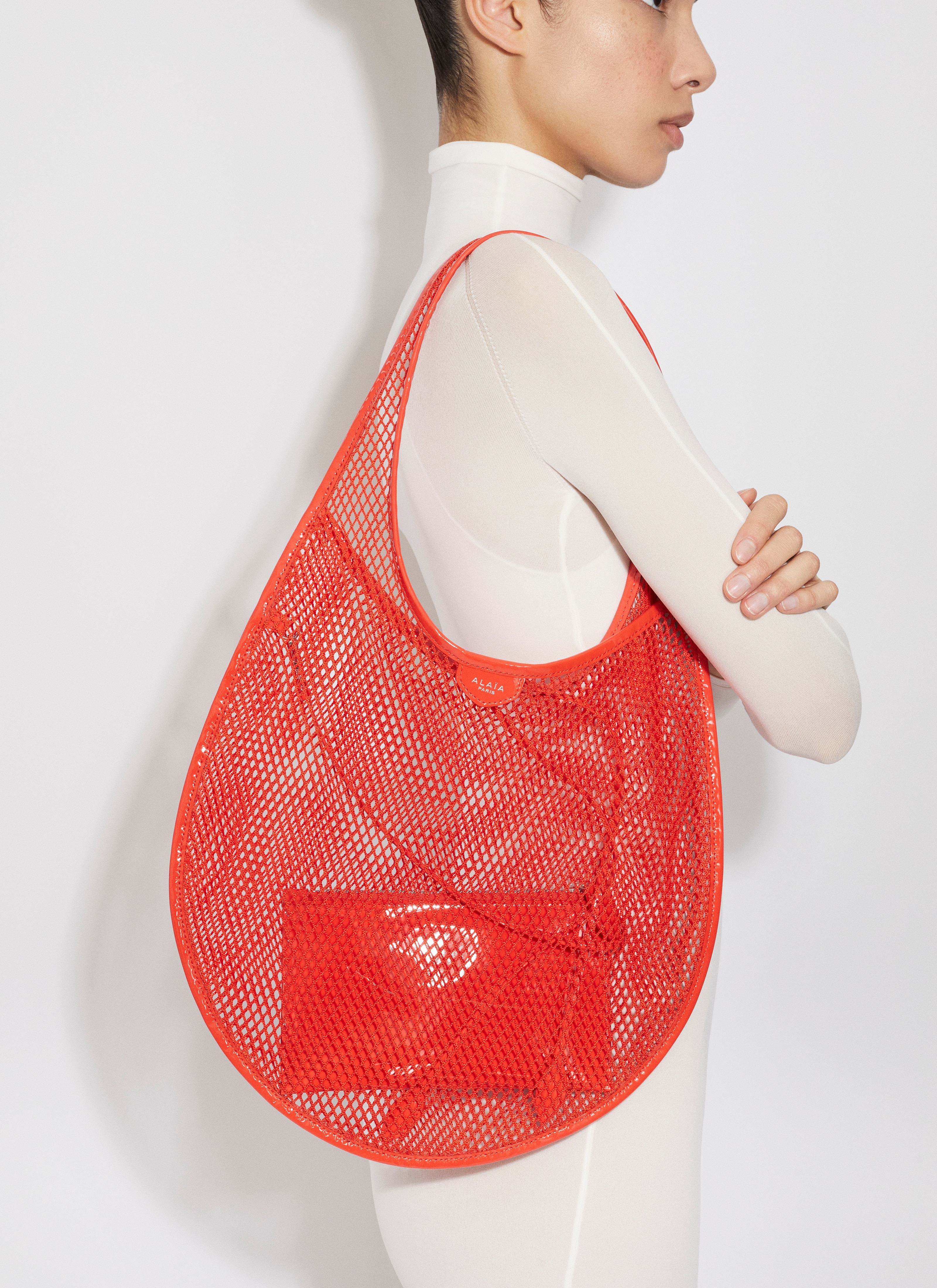 ALAÏA ORANGE ONE PIECE MEDIUM BAG IN FISHNET