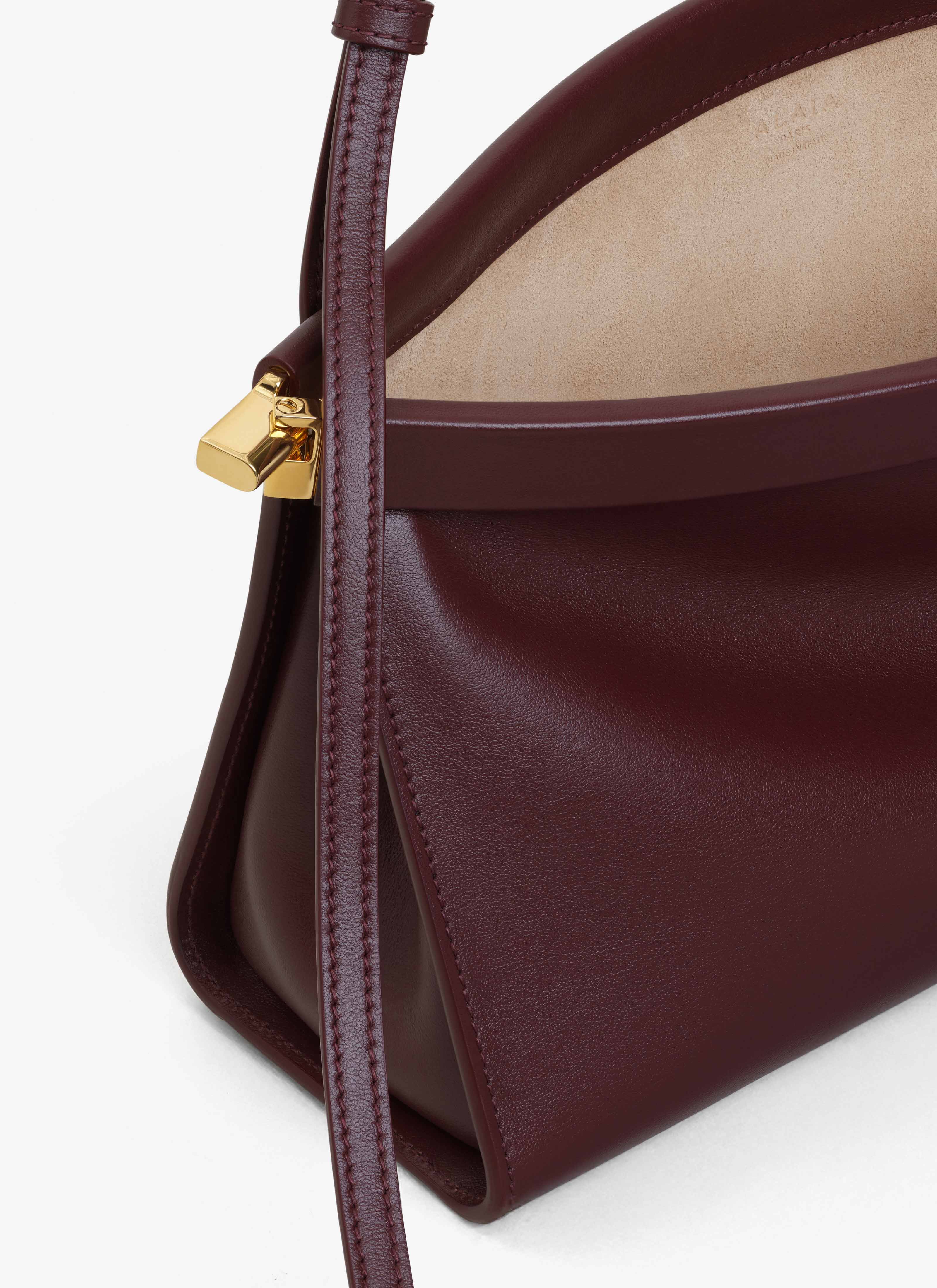 ALAÏA GARNET RED LE CLICK EAST WEST MEDIUM BAG IN LEATHER