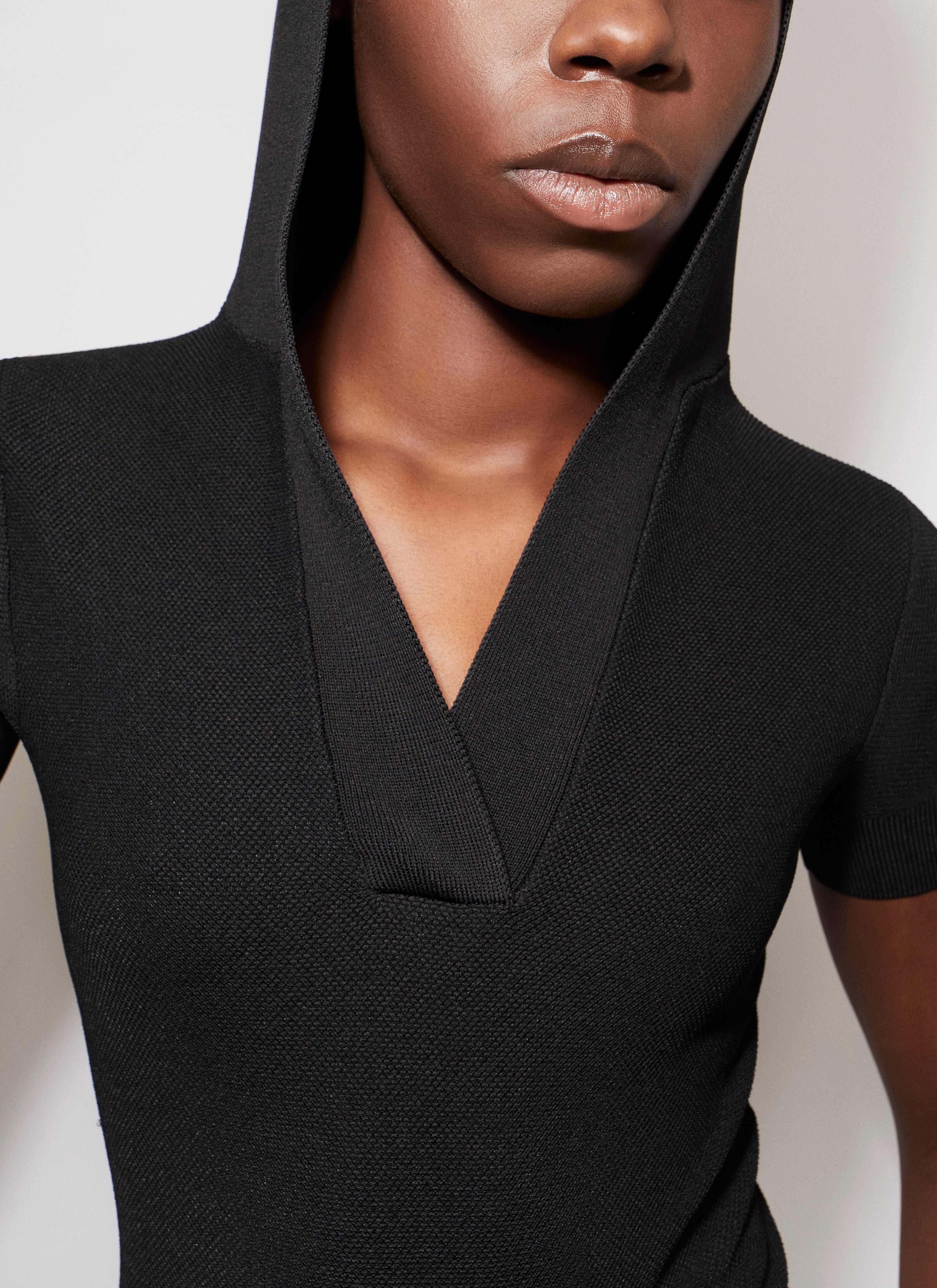ALAÏA BLACK HOODED TOP IN PIQUE KNIT